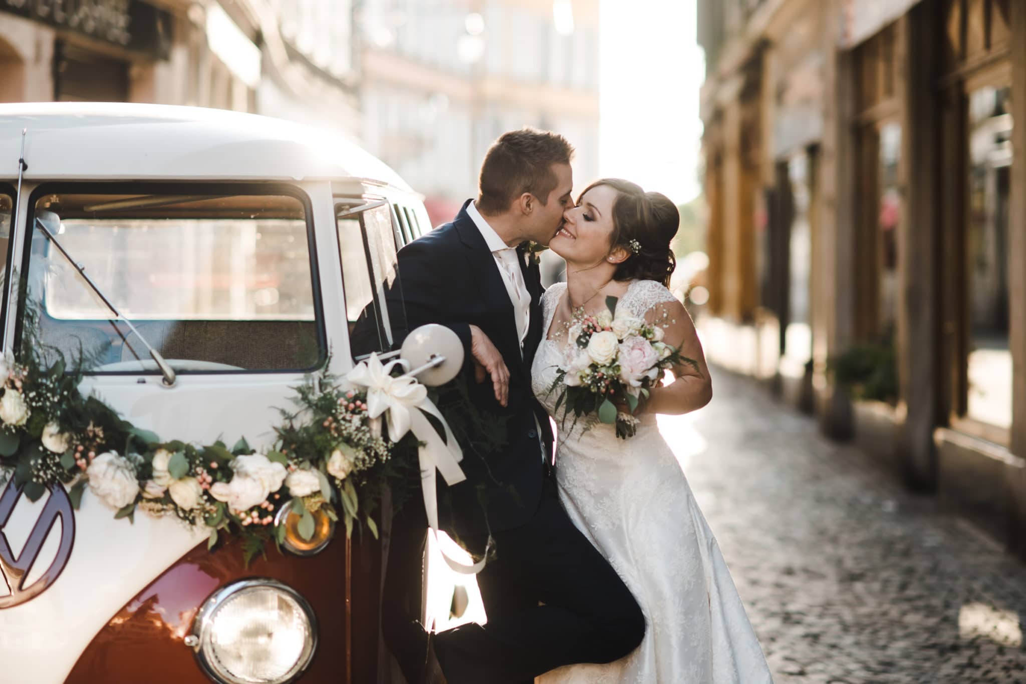 Les mariés posent sur les pavés de Vevey avec leur bus VW