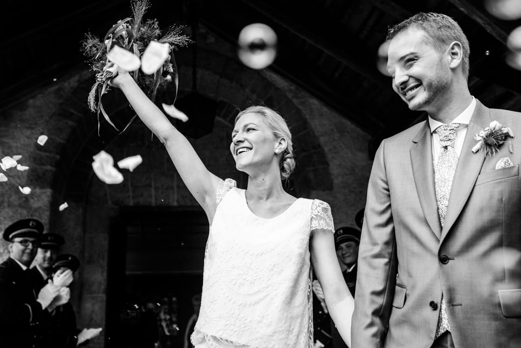 Les mariés saluent leurs invités à la sortie de l'église